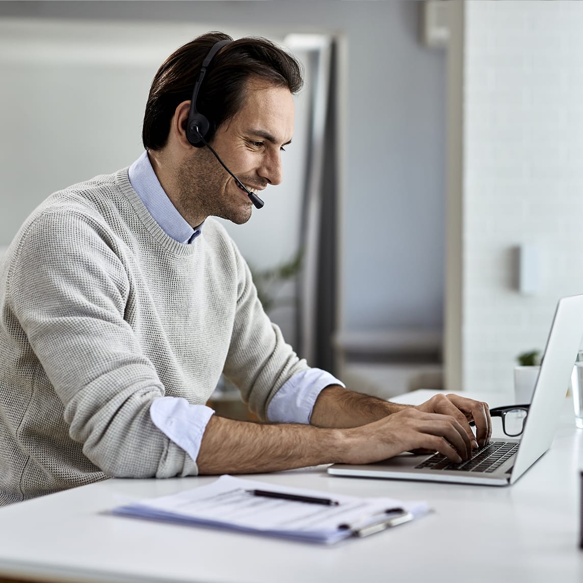 Man sitting at desk working on laptop